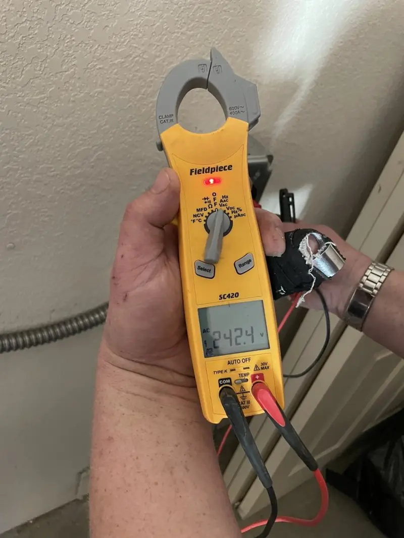 Voltage testing with clamp meter during Electrical Installation Services in Greenport